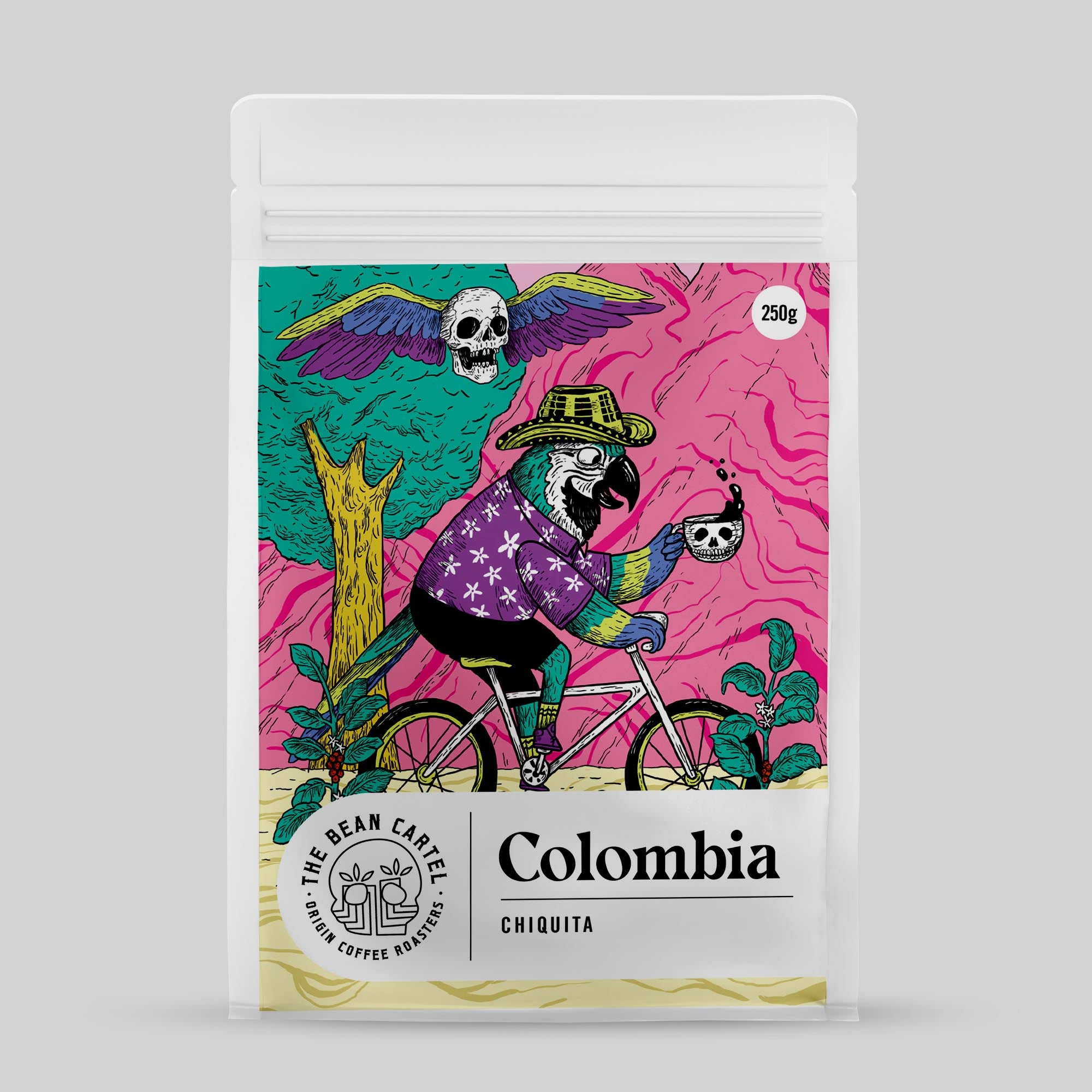 Single Origin Coffee Beans from Colombia package with colorful design featuring a parrot and skull on a pink background by The Bean Cartel